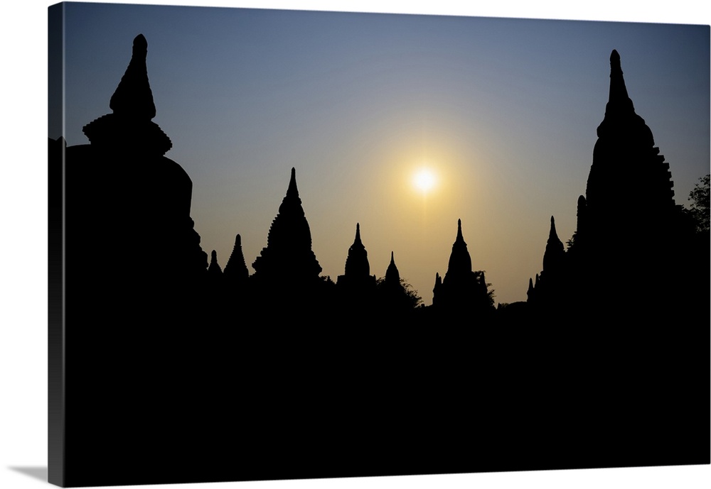 Silhouetted Buddhist temple at sunset; Bagan, Mandalay Region, Myanmar