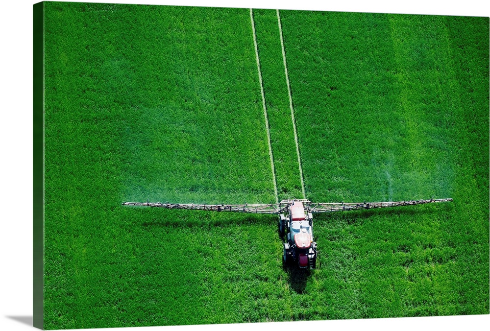 Aerial view of spray application in green agricultural field on the Eastern shore of Maryland, Wye Mills, USA.