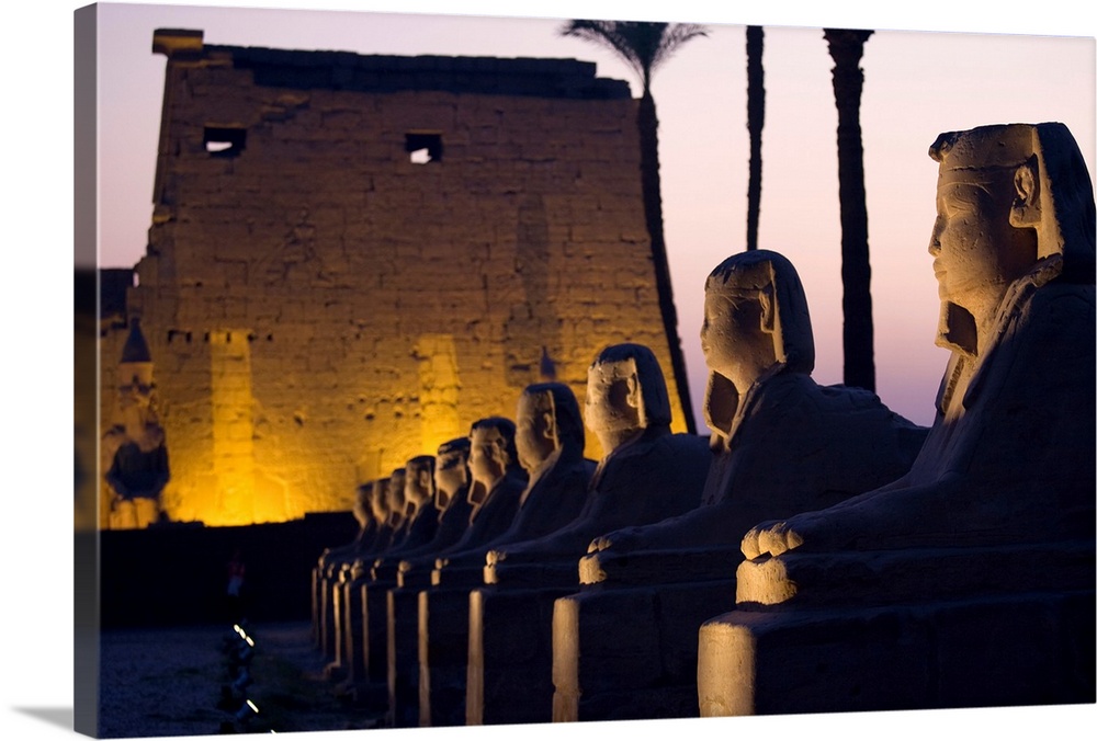 Stone Statues And The Luxor Temple Along The Nile River; Luxor, Egypt