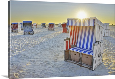 Sun Rising Over Beach Chairs At Beach, North Sea, Schleswig-Holstein, Germany