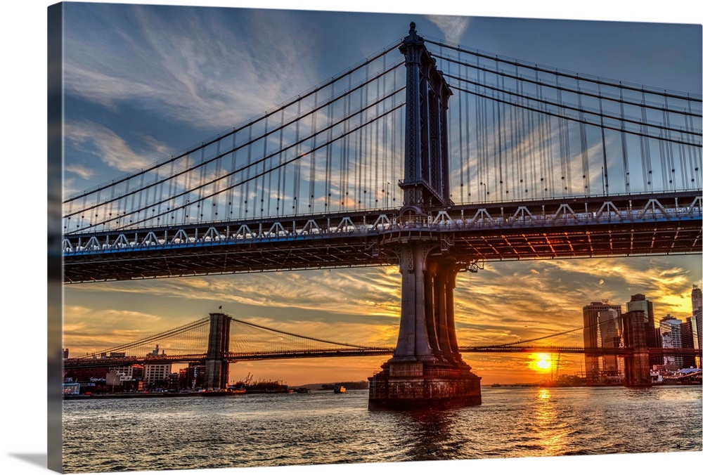 Sun setting behind Manhattan and Brooklyn Bridges; New York City, New York, United States of America
