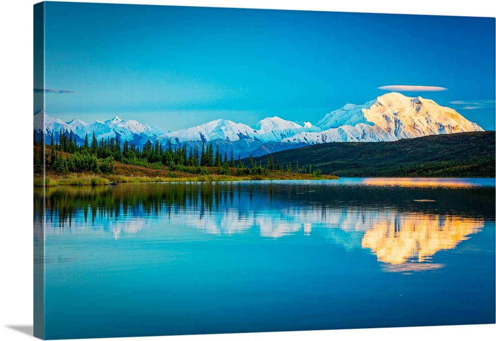 Sunset glow on Mount Denali (McKinley) reflects on Wonder Lake in autumn in Denali National Park and Preserve, Interior Al...