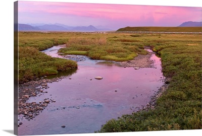 Sunset light reflecting in Sagavanirktok River with trans Alaska Pipeline