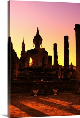 Thailand, Sukhothai, Wat Mahathat, Buddha And Pillars Backlit At Sunset
