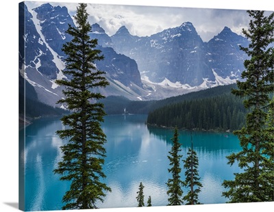 The Canadian rocky mountain peaks and Moraine Lake with forests along the shoreline