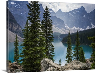The Canadian rocky mountain peaks and Moraine Lake with forests along the shoreline