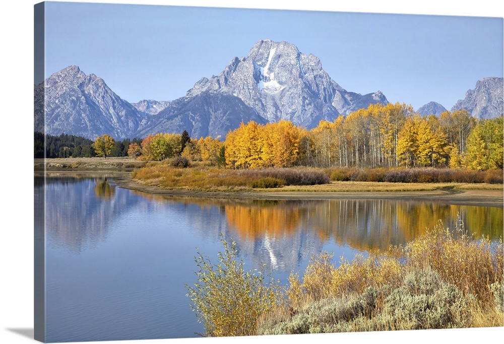 The Grand Tetons in Grand Teton National Park reflecting fall colors in the Snake River, Wyoming, United States of America