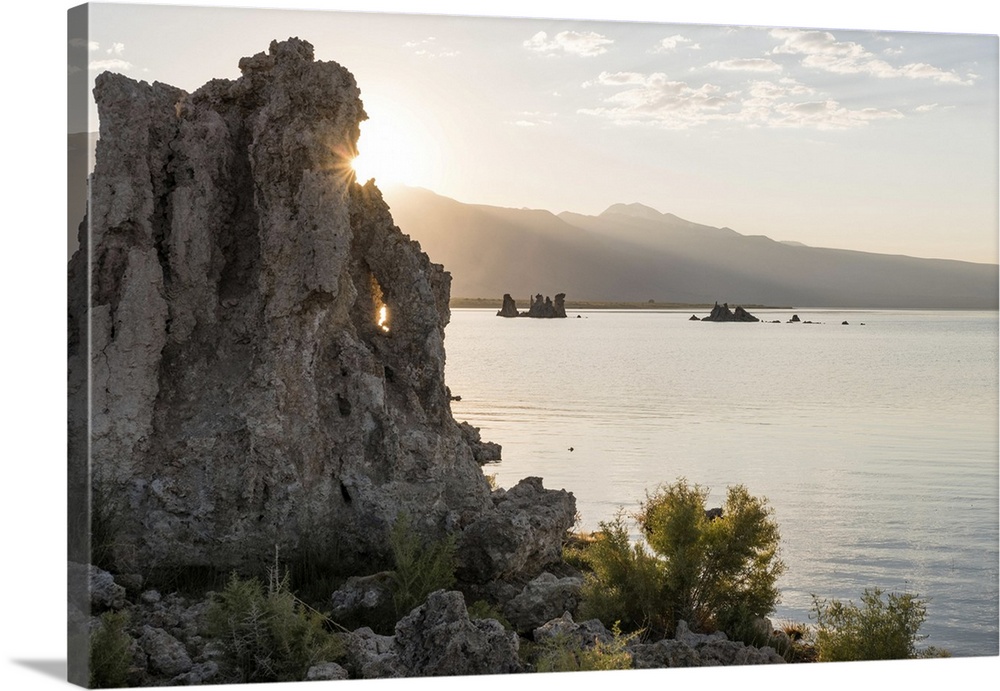 The sun peeks from behind a tufa at Mono Lake South Tufa. Mono Lake, California, United States of America