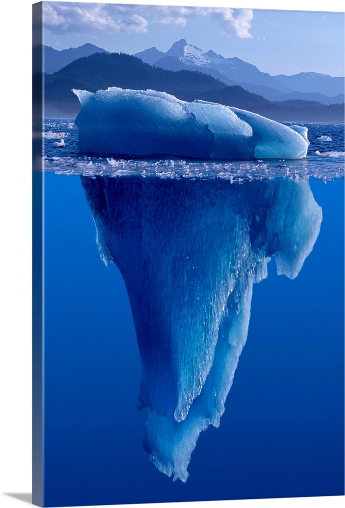 A composite photograph of a large Iceberg as seen from under and above the water.