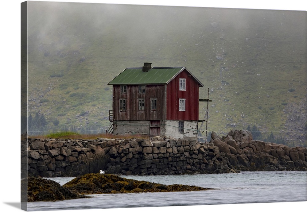 Traditional fishing village house next to the shoreline in Lofoten, Lofoten, Arctic Circle, Norway