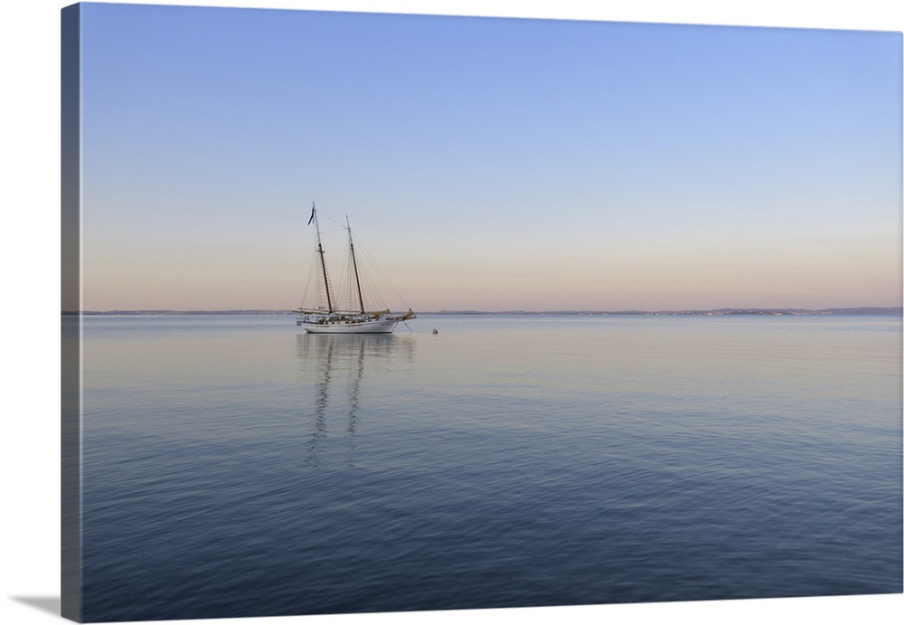 Two masted sailboat anchored on Lake Garda (Lago di Garda) at dawn at Bardolinoin Veneto, Italy