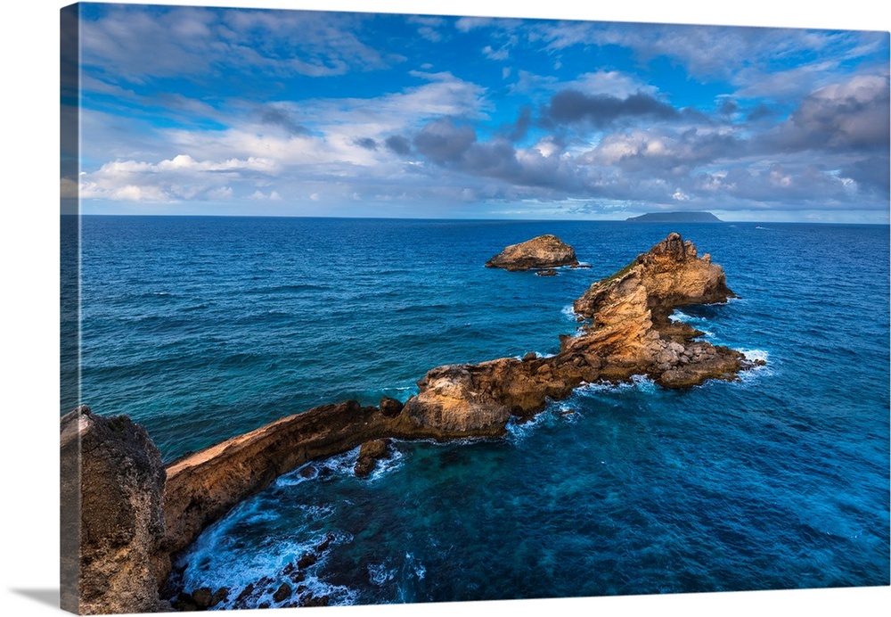 Vibrant Caribbean Sea surrounding the rock formations on the Pointe des Chateaux peninsula on Grande-Terre, Guadeloupe, Fr...