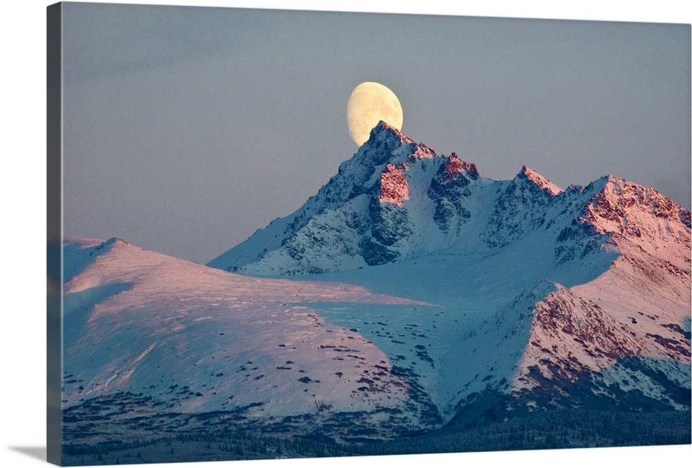 View of moon rising behind O'Malley Peak, Chugach Mountains, Anchorage, Southcentral Alaska, Winter