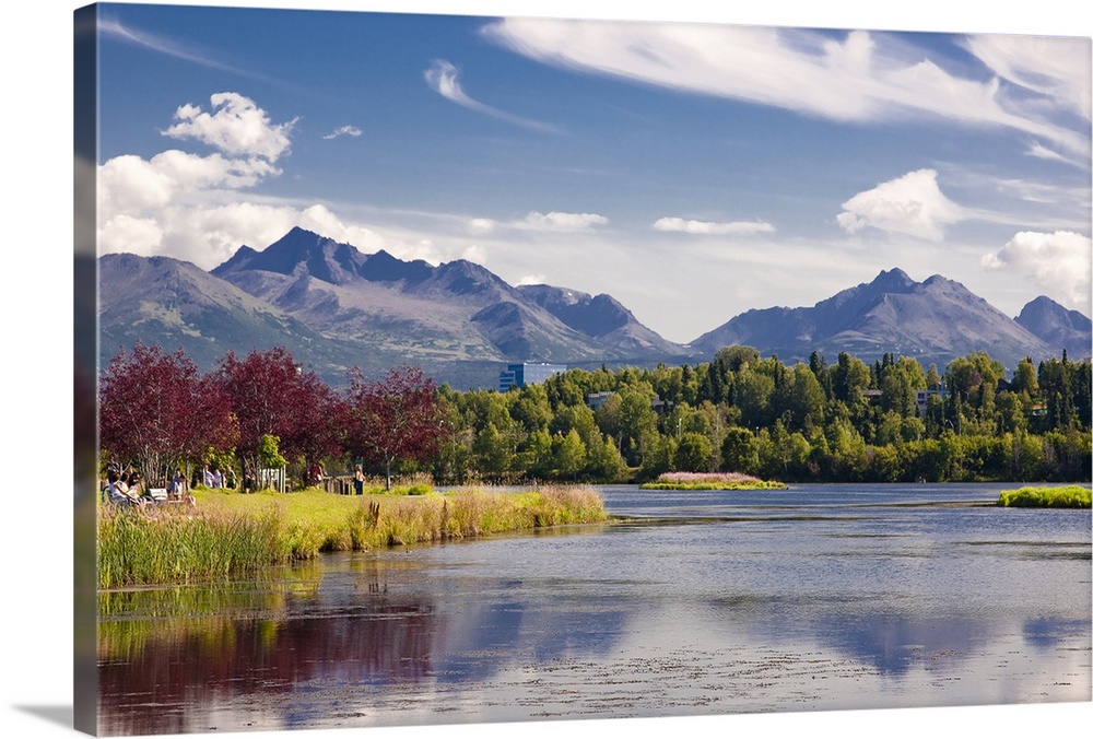 Giant, landscape photograph of the Westchester Lagoon in the summer, surrounded by trees, and the Chugach Mountains in the...