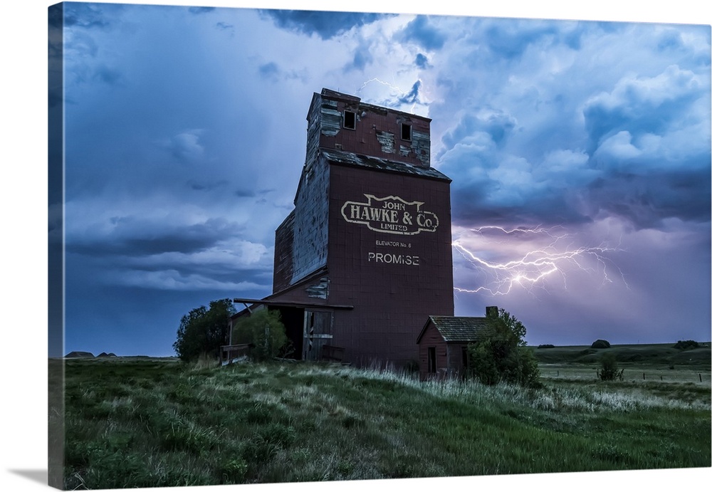 Weathered grain elevator and electrical storm on the prairies; Saskatchewan, Canada