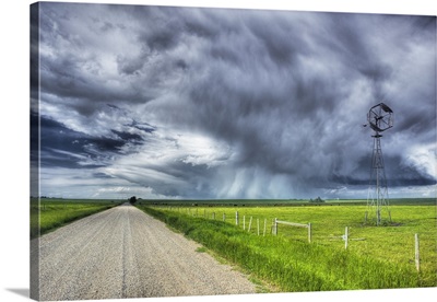 Windmill And Country Road With Storm Clouds Near Carstairs, Alberta