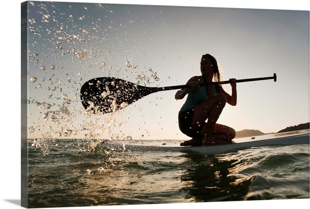 Woman Paddling While On Her Knees On Surf Board, Tarifa, Andalusia, Spain