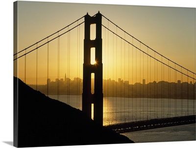 Yellow Sunrise Behind The Golden Gate Bridge With Skyline; San Francisco, California