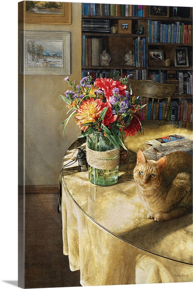 Vertical image of a orange tabby sitting on a table with a glass vase of flowers and a newspaper.