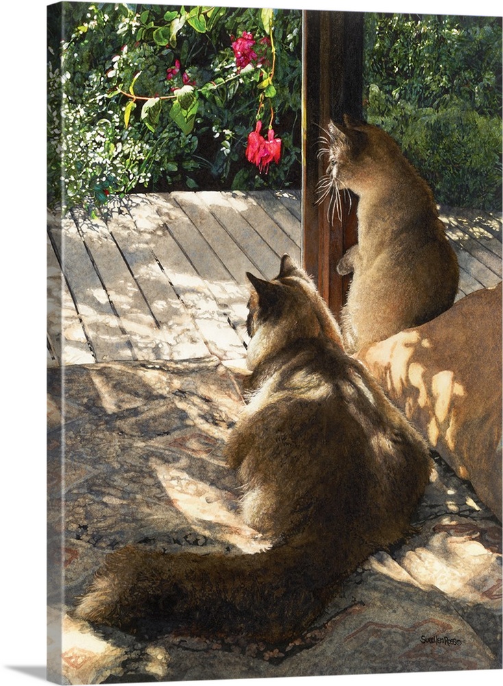 Vertical image of two cats on alert while sitting on a wooden deck.