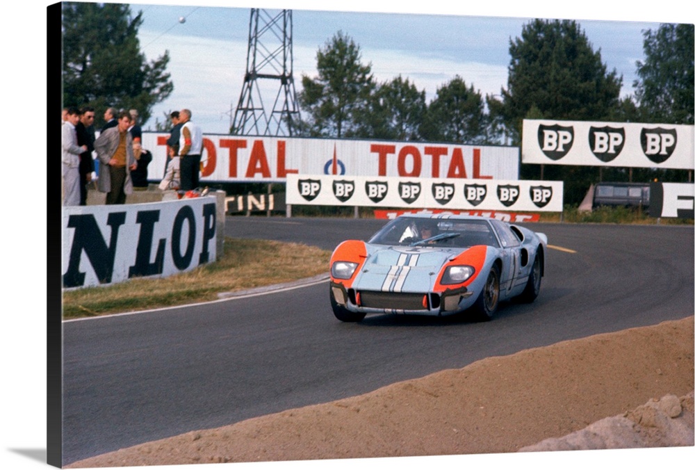 Ken Miles and Denis Hulme driving their Ford Mark II at the Mulsanne Hairpin at the 1966 LeMans Race.