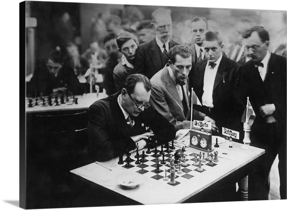 Alexander Alekhine siting while playing a chess. - Reprint