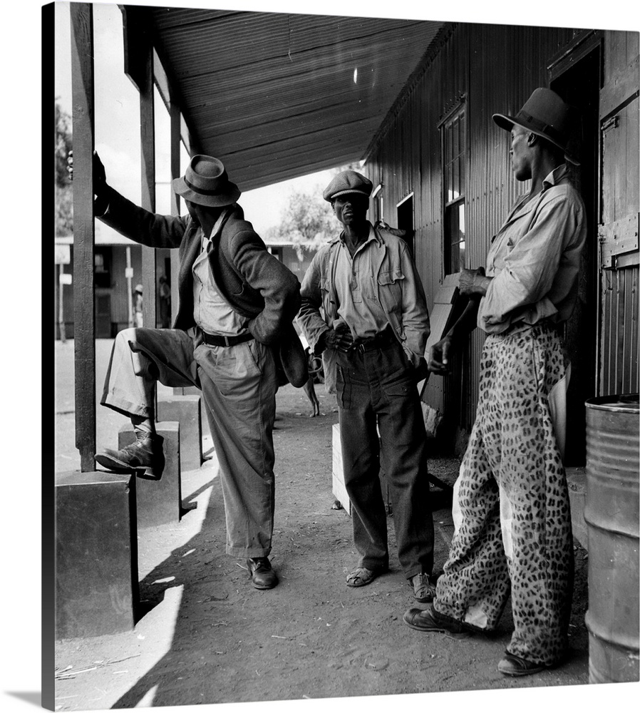 29th April 1950:  Three members of the Bamangwato tribe standing outside a trader's store in Serowe, Botswana Original Pub...