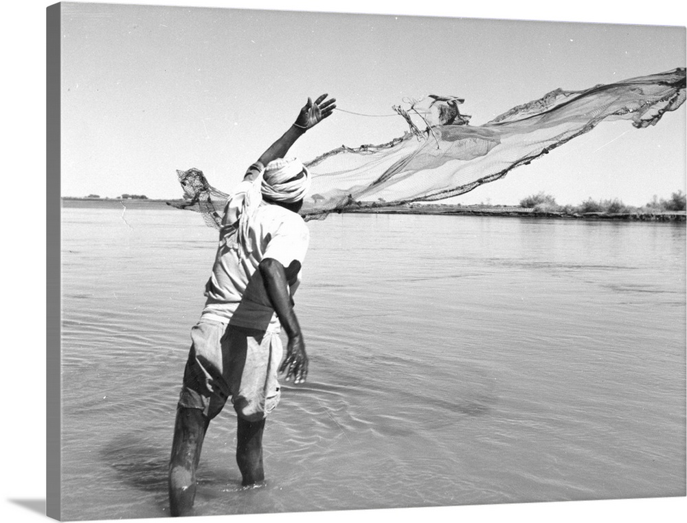 A Sudanese fisherman trapping catfish in the muddy waters near Khartoum  Original Publication: Picture Post - 5638 - Sande...