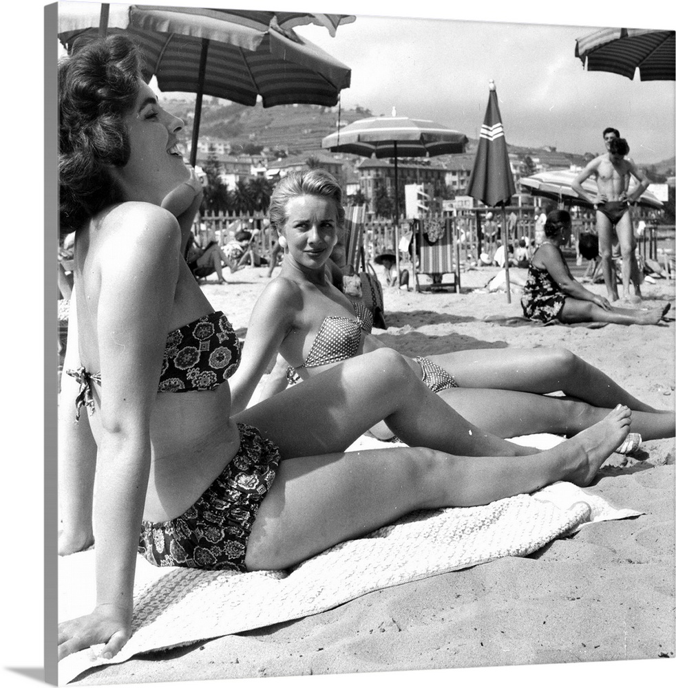 23rd July 1955:  British fashion models cruising along the Cote d'Azur on board the 'Bonaventura' yacht relax in a beach o...