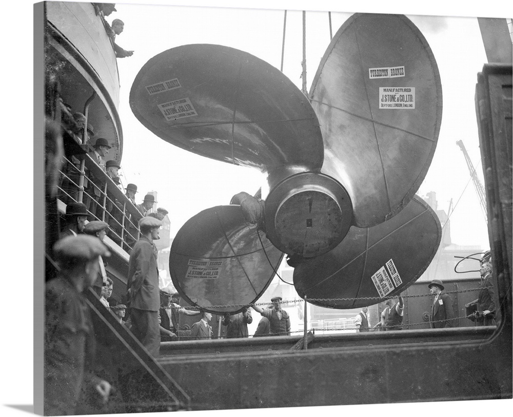 The fourth and last of the giant propellers for the new Cunard White Star liner Queen Mary is hoisted aboard the steamship...