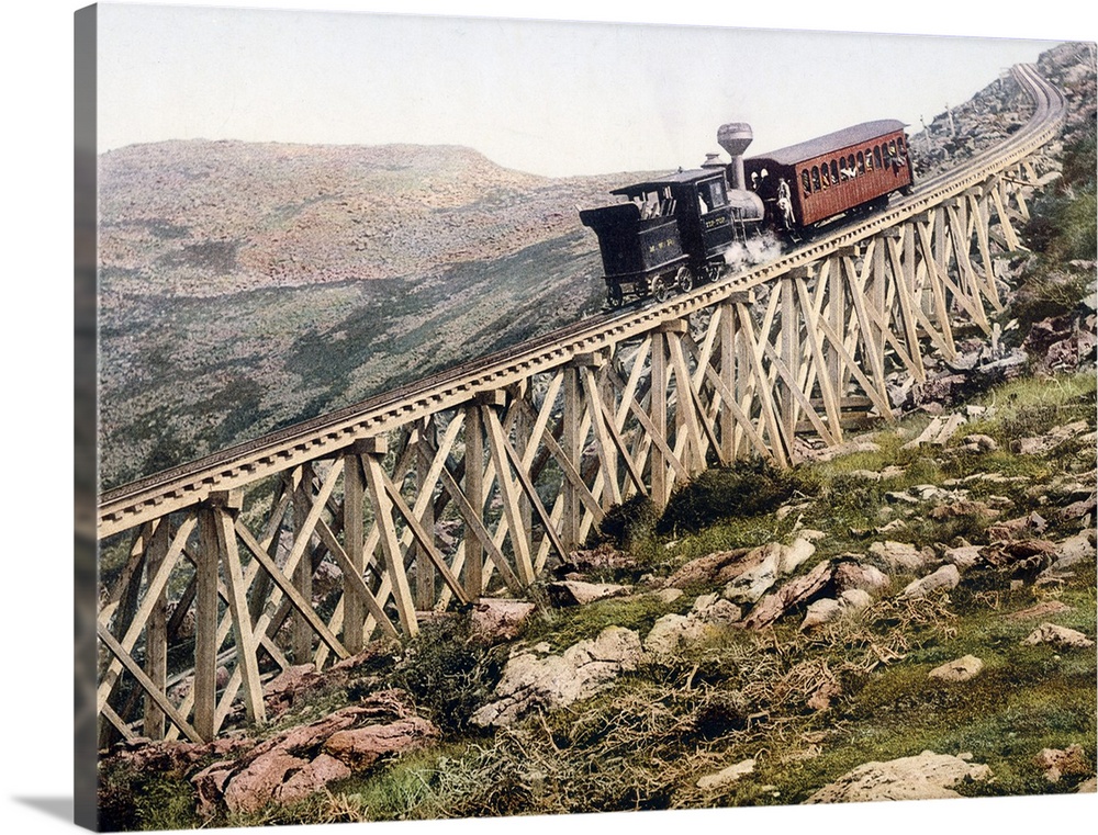 A locomotive pushes a passenger car up a wood railway to the top of a mountain in this vintage landscape photograph.