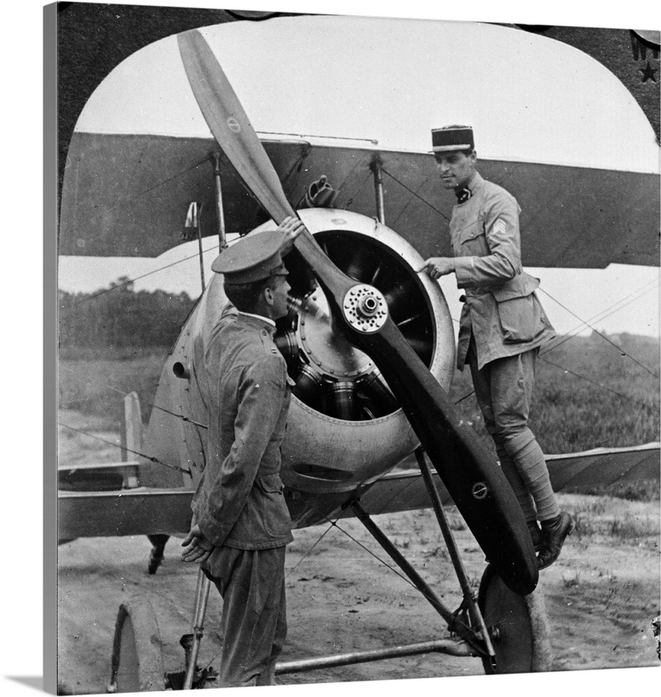 Lt Le Maitre of the French Aviation Forces in America explains the mechanism of a Nieuport biplane to an American pilot, F...