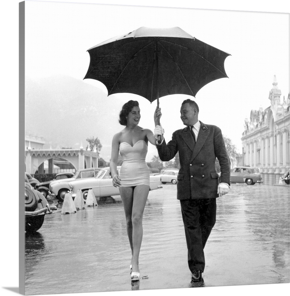 Swimwear model Margaret, is offered shelter from the rain under a giant umbrella in Monte Carlo  Original Publication: Pic...