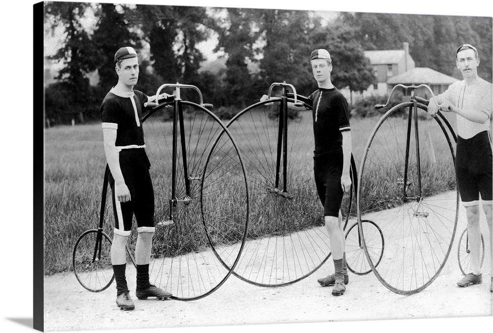 The owners of three penny farthing bicycles stand proudly with their machines