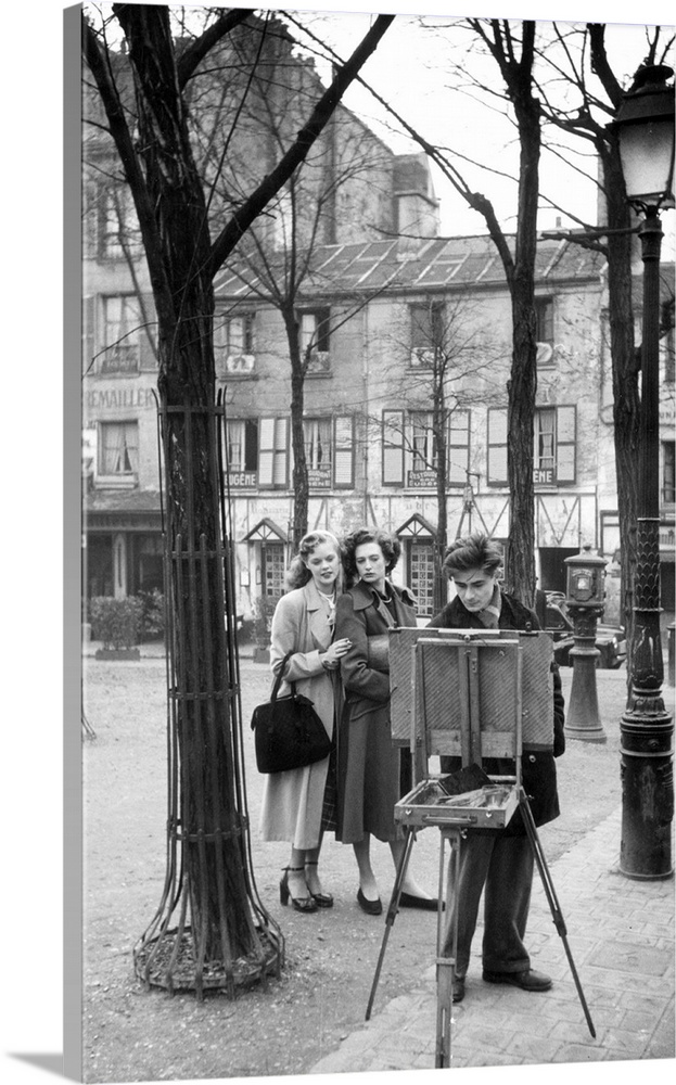 Two British women looking at a picture an artist is painting in the Place du Tertre in Montmartre, Paris   Original Public...