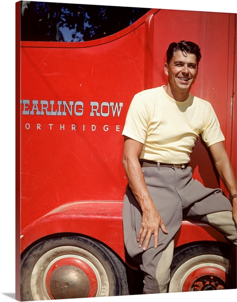 American actor and politician Ronald Reagan poses in front of a red trailer belonging to the Yearling Row ranch, Northridg...