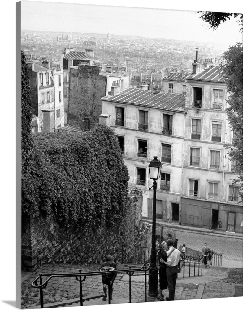 A couple kissing on Bastille day on the steps of Montmartre, Paris, France  Original Publication: Picture Post - 5076 - Ba...