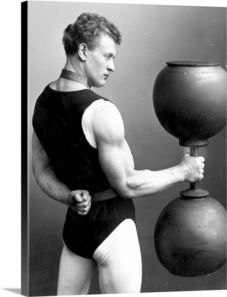 circa 1890:  German strongman Eugene Sandow (1867 - 1925) lifting a large dumb-bell