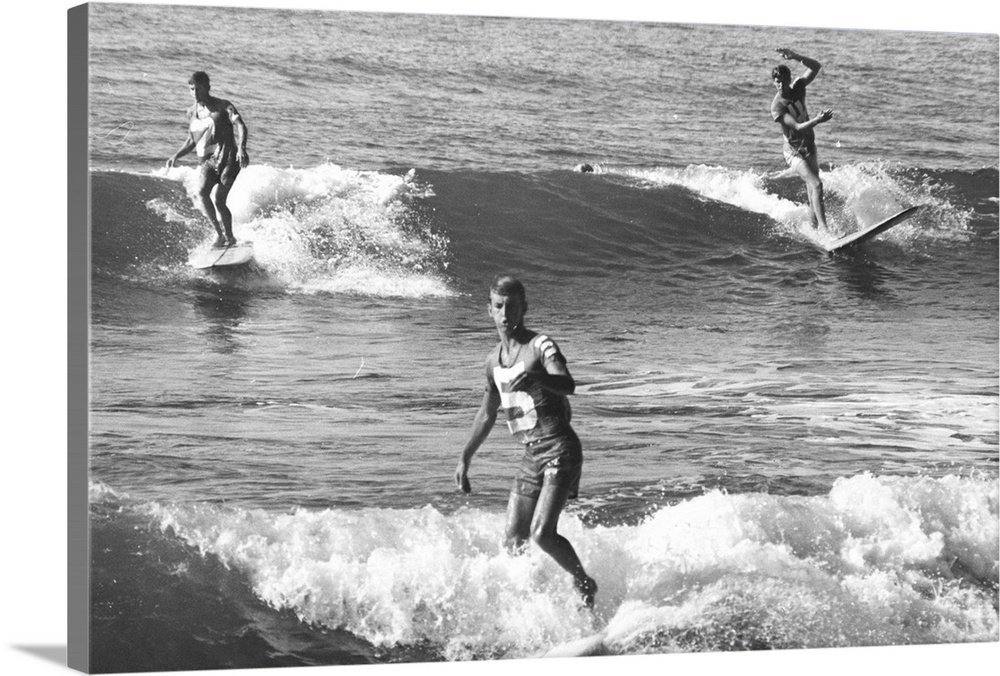 circa 1970:  L to r, Jeff Hakman, Bob Conneeley and John Day riding the small waves on a pacific beach