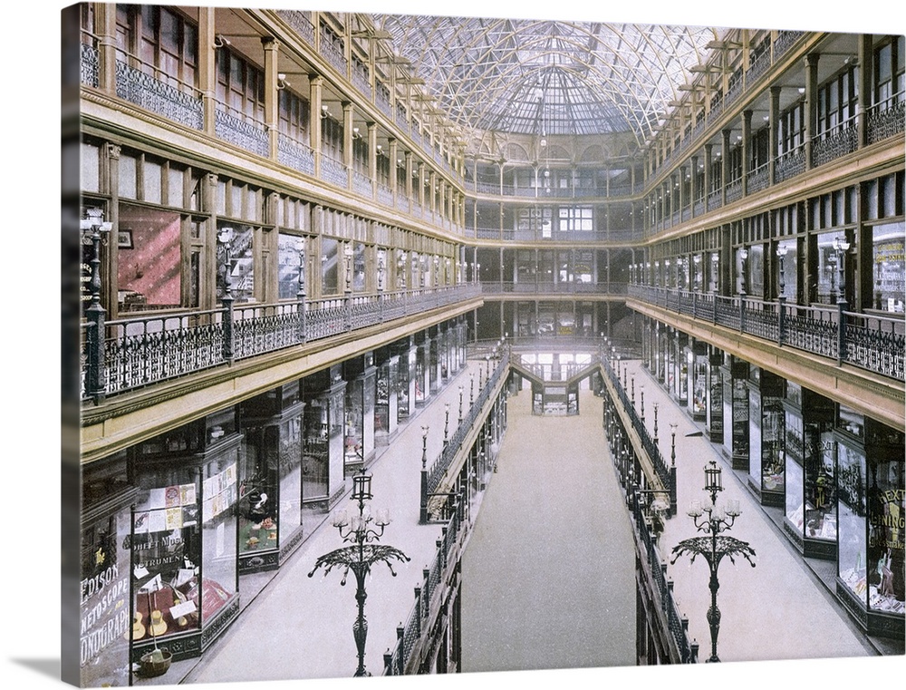A vintage picture taken inside of the arcade showing various shops on three levels on both sides of the building.