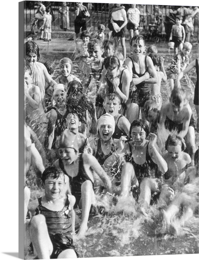14th August 1937:  A group of children from West Ham, London enjoy a dip in the local paddling pool