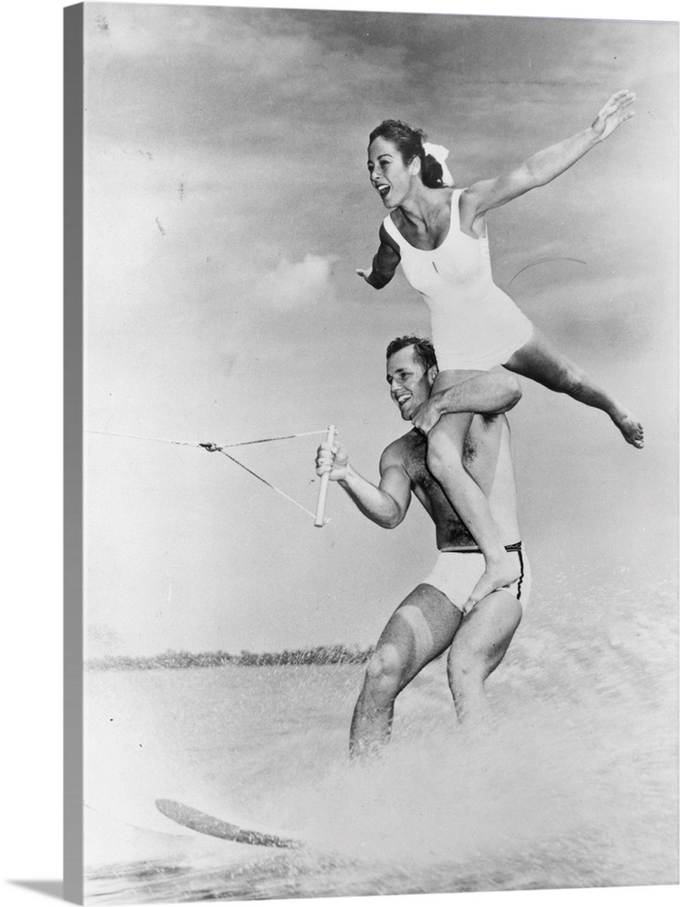 21st February 1968:  Water-ski champion Clara Parks balances on the shoulders of champion Don Seyez as they speed across L...