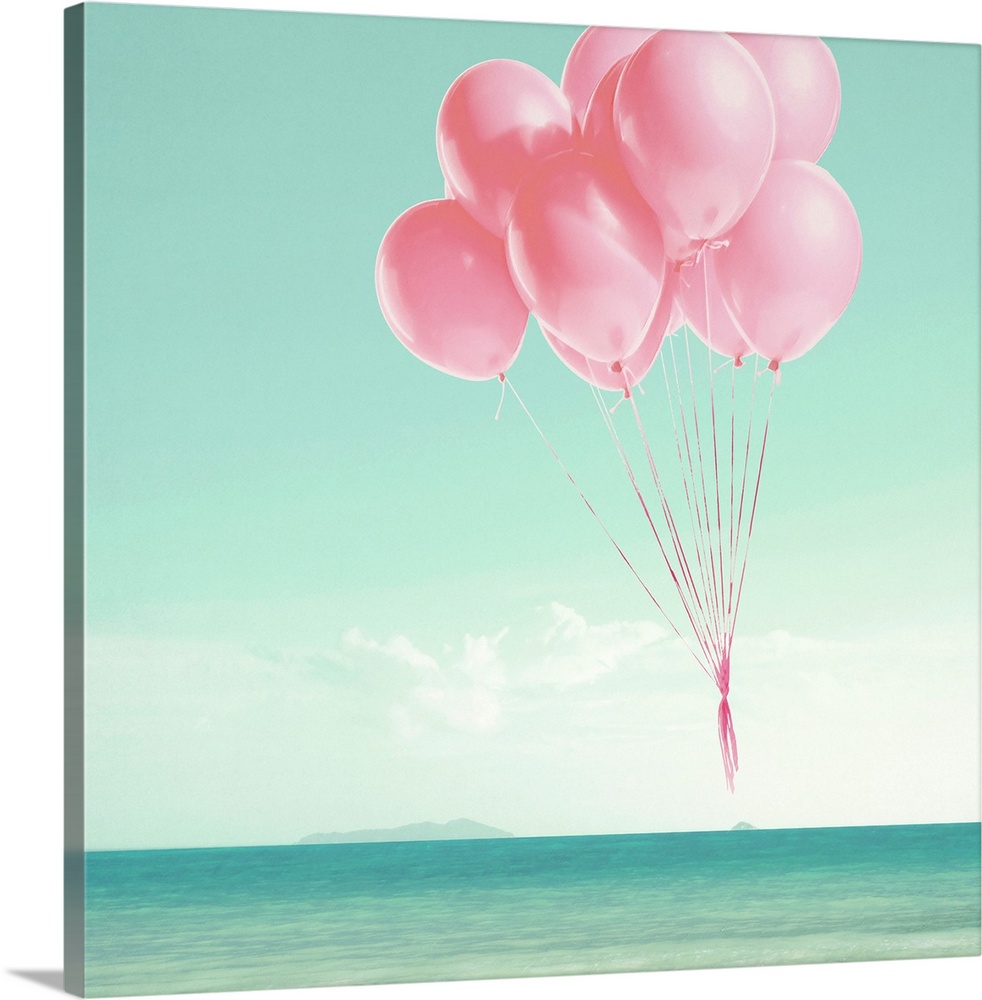 Pink balloons floating over the ocean on a square background.