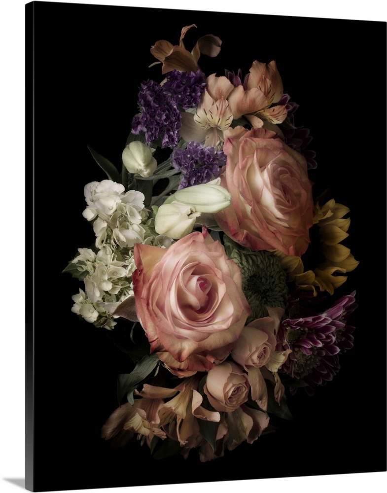Bouquet of roses and assorted flowers on black, in low light, creating a vintage feel.