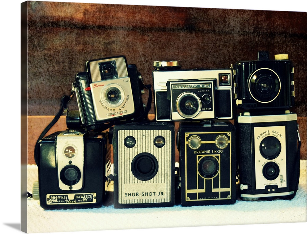 Photograph of stacked vintage cameras.