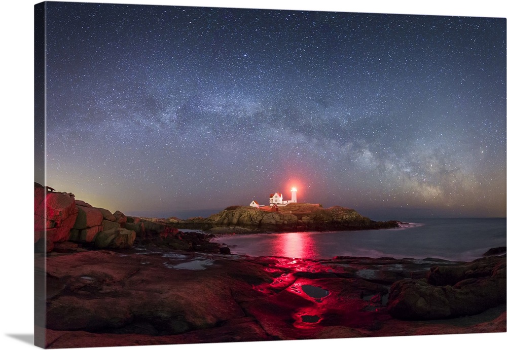 Long exposure photograph of the milky way and stars over Nubble Lighthouse, ME.