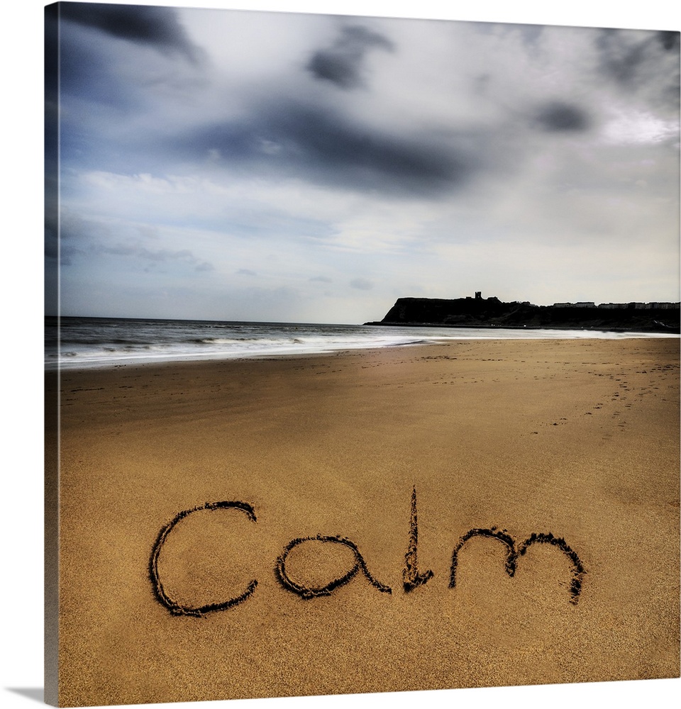Photo of the word written in the sand: Calm.