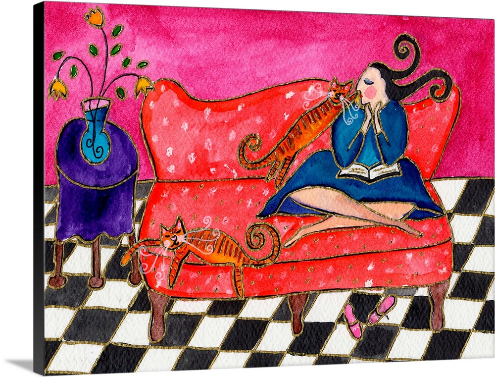 A woman sitting on a red couch with two striped cats.