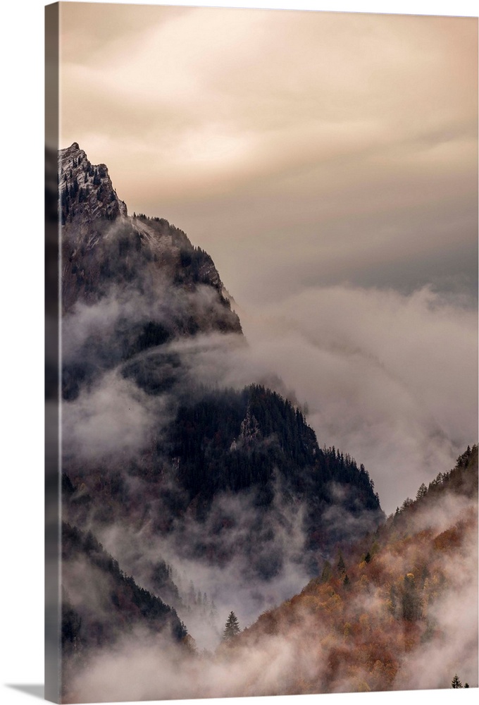 Landscape photograph of foggy mountain cliffs.