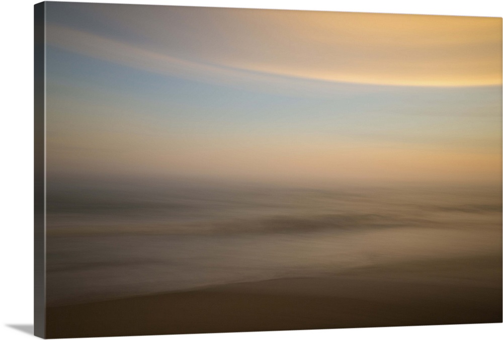 An artistic abstract photograph of a light blue and orange motion blurred cloudscape.